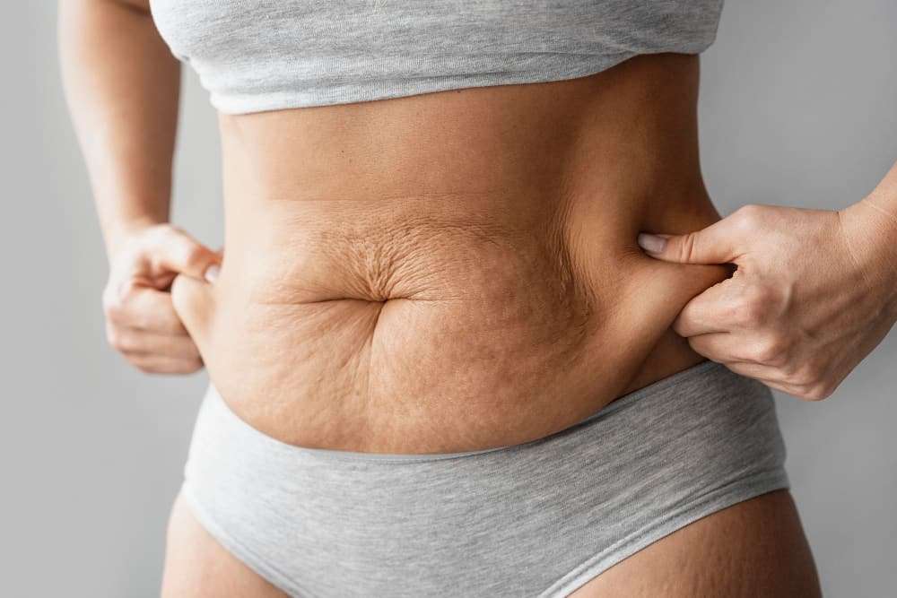 close up hands holding body fat